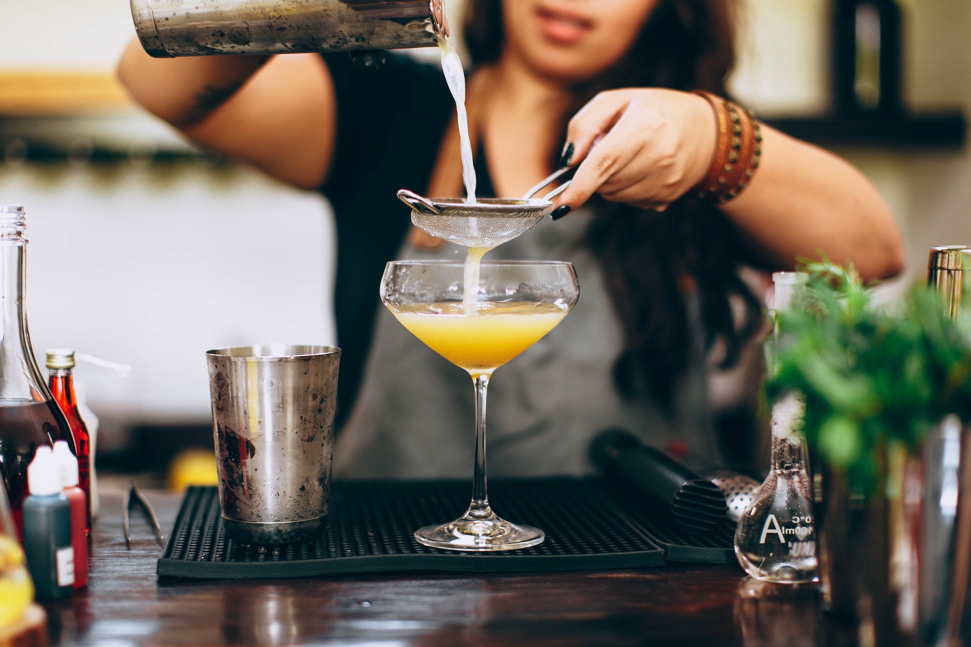 A bartender is preparing a cocktail